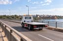 Azemmour: a flatbed tow truck crosses the bridge over the Oum Er-Rbia, the medina in the distance.